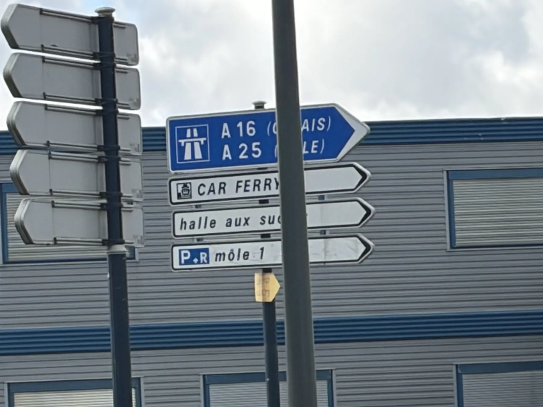 Road signs for the A16 towards Calais and Car Ferry at the terminal