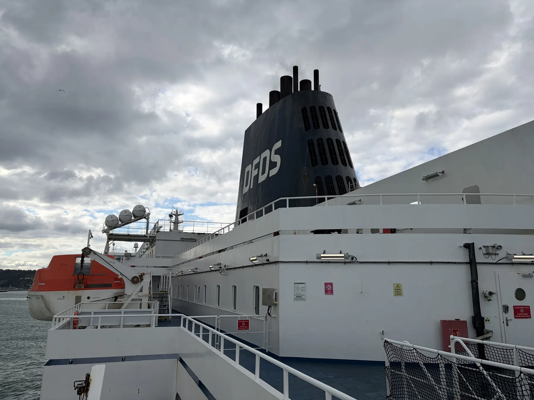 The DFDS funnel and lifeboats of the Delft Seaways under a blue sky