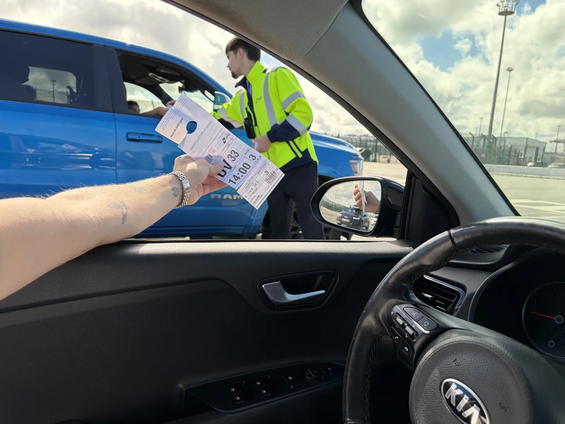 A DFDS agent checking the hanger at the cars in the queue