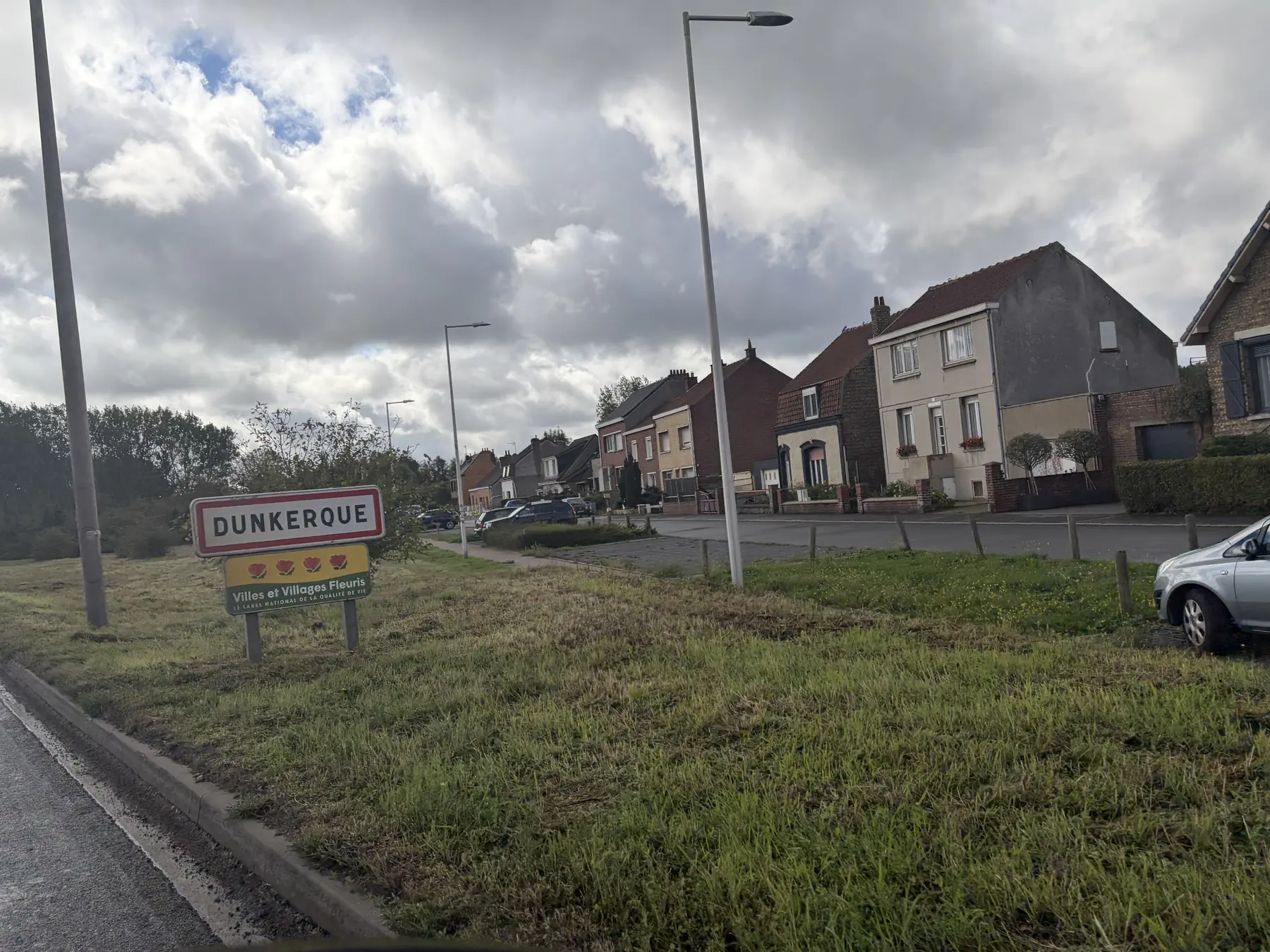 Dunkerque town name sign by the roadside